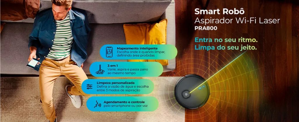 Mulher sentada no sofá de sua casa controlando seu Smart Robô Aspirador Wi-fi Laser da Positivo Casa Inteligente pelo celular, com as vantagens do produto descritas ao seu lado.